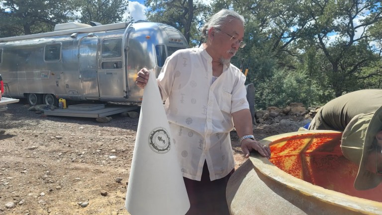 Sangha member preparing contents for the Stupa construction